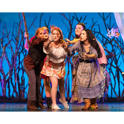 Hermia and other cast members staring oddly at a phone.