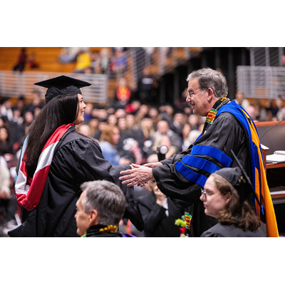 President Bitterbaum congratulates a master's degree candidate