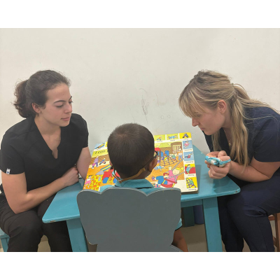 Students working with a child at the clinic