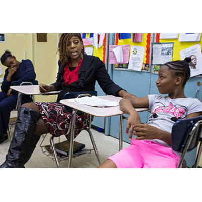 2013 image of Shaw-Hester in a classroom, courtesy of The New York Times
