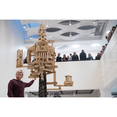 Artist speaking about a sculpture in the atrium