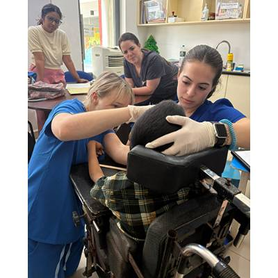 Helping a client swallow as Rachel King looks on