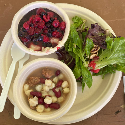 Plate of food served at the SUNY Binghamton Three Sisters Garden Harvest, featuring corn mush with berries (top left) and Haudenosaunee Hominy soup (bottom left).