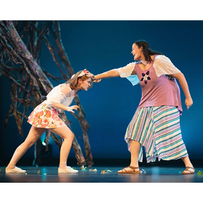 Helena preventing Hermia from lunging forward by holding her head.