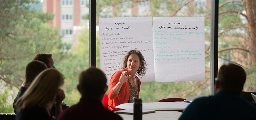 A group discusses hands-on educational leadership strategies