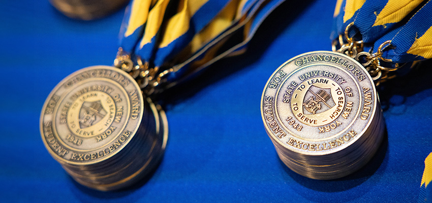 SUNY Chancellor's Award medals displayed on blue background