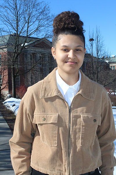 Krystal Puesan stands with Old Main in the background