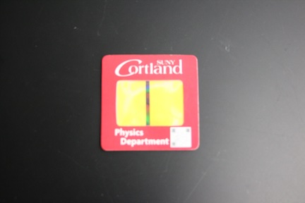 picture showing a the grating with an a linear aperature formed from two sticky notes attachd to the slide