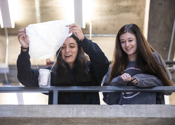 Two students do the egg-drop experiment in Bowers Hall