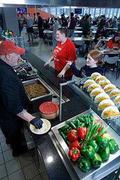 Food service worker taking student orders