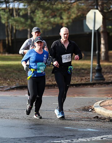 Lindsay Ball (front left) and Kevin Dames run the Syracuse Half Marathon.
