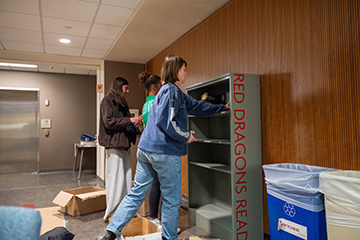 Red Dragon Read Bookcase in the Education building being stocked