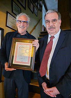 Martin Borelli holding award with President Bitterbaum