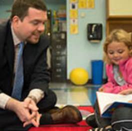 A School Building Leader in a classroom with children