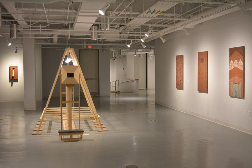 View into the central gallery at Dowd Gallery featuring sculptural objects produced by Buffalo-based sculptor Gary Sczerbaniewicz.