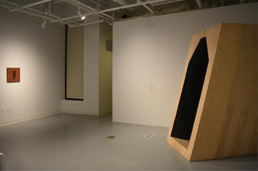 View into the east gallery at Dowd Gallery featuring sculptural objects produced by Buffalo-based sculptor Gary Sczerbaniewicz.   