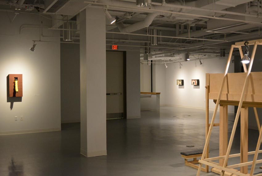 View into the central gallery at Dowd Gallery featuring sculptural objects produced by Buffalo-based sculptor Gary Sczerbaniewicz. 