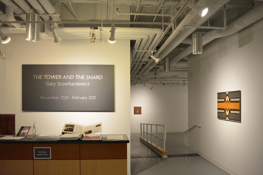 View into the west gallery at Dowd Gallery featuring sculptural objects produced by Buffalo-based sculptor Gary Sczerbaniewicz.