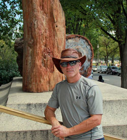 Steven B. Broyles poses in front of an exhibit