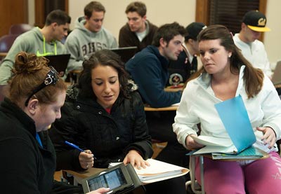 Students working in small groups to learn current economics technology