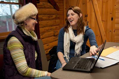 Professional writing professor giving hands-on instruction to a Professional Writing Bachelor's student