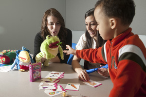 Center for Speech and Hearing Disorders Students working with a child