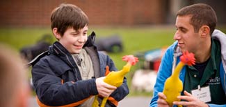Young boy and Cortland student volunteer