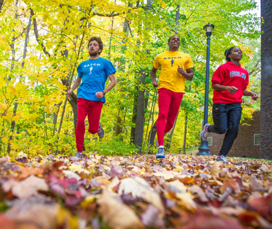 runners cross the campus three joggers