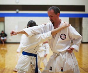 woman and man demonstrate sparring in karate class sparring match