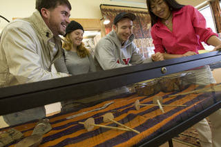 Students peruse a glass display case.
