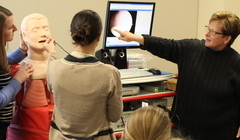 Gilroy, right, instructs students during class.