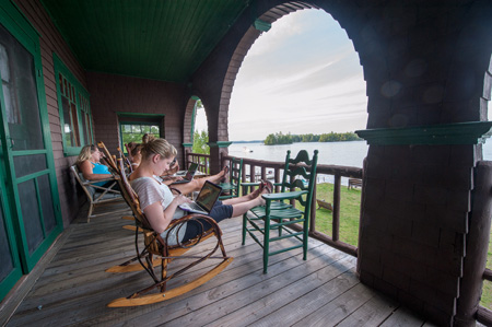 students relaxing on a porch