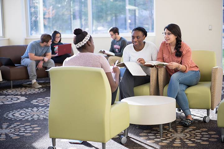 International students hanging out in a residence hall lobby